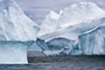 Stock photo of two blue large icebergs floating in Iceberg Alley, an arctic scene captured while iceberg watching in the waters off the Great Northern Peninsula, Northern Peninsula, Newfoundland, Canada.