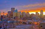Stock photo of the Calgary skyline with the Calgary Tower and Centre Street Bridge along the Bow River at sunset after a light snowfall in the City of Calgary, Alberta, Canada.