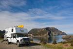 Stock photo of a camper parked an open area in Bottle Cove at the end of the Humber Arm near Lark Harbour, Newfoundland, Canada.