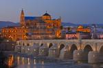 Stock photo of the Puente Romano (bridge) spanning the Rio Guadalquivir (river) and the Mezquita (Cathedral-Mosque) during dusk in the City of Cordoba, UNESCO World Heritage Site, Province of Cordoba, Andalusia (Andalucia), Spain, Europe.