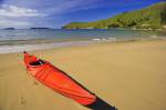 Stock photo of a kayak on the beach at Titirangi Bay, Marlborough, South Island, New Zealand.