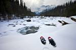 Stock photo of snhowshoes in the snow on the banks of Mistaya River during winter with Mount Sarbach in the background, Mistaya Canyon, Icefields Parkway, Banff National Park, Canadian Rocky Mountains, Alberta, Canada.