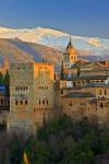 Stock photo of The Alhambra (La Alhambra) a Moorish citadel and palace (designated a UNESCO World Heritage Site in 1984), back dropped by the snow capped Sierra Nevada mountain range seen from Mirador de San Nicolas in the Albayzin district at sunset, Cit
