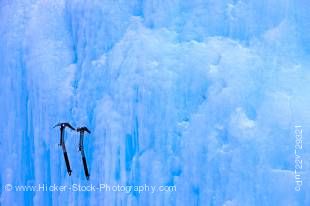 Stock photo of two ice picks lodged in a frozen wall of ice at the Upper Falls during winter, Johnston Canyon, Banff National Park, Canadian Rocky Mountains, Alberta, Canada. 