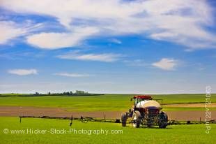 Stock photo of a farmer spraying crops by tractor near the town of Rockglen, Southern Saskatchewan, Canada.
