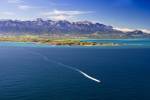 Stock photo of aerial view of the Kaikoura Peninsula and a whale watching boat during a Whale Watching flight with Wings over Whales, Kaikoura, East Coast, South Island, New Zealand.