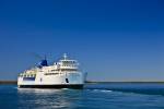 Stock photo of Chi-Cheemaun, the large passenger and vehicle ferry departing Tobermory on the Bruce Peninsula for Manitoulin Island in Lake Huron, Ontario, Canada.