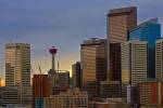 Stock photo of modern commercial high rise buildings and the Calgary Tower against a cloudy sky in the city of Calgary, Alberta, Canada. 