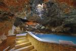 Stock photo of the relaxing geothermal hot springs pool and a concrete walkway in the Cave and Basin National Historic Site, Sulphur Mountain, Banff National Park, Alberta, Canada.