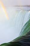 Stock photo of the Canadian Horseshoe Falls (Niagara Falls) plunging over the edge with a rainbow above, Ontario, Canada