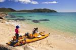 Stock photo of Kayakers on the beach at Arch Point, Abel Tasman National Park, Tasman District, South Island, New Zealand.