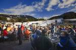 Hundreds of patrons seen seated outside the Longhorn Saloon and Grill, an apres-ski bar at the base of Whistler Mountain, Whistler Village, British Columbia, Canada. People dressed in their warm winter clothing enjoy food and drink at tables outside this 