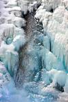 Stock photo of a frozen Lower Falls of the Johnston Creek during winter with ice and snow formations, Johnston Canyon, Banff National Park, Canadian Rocky Mountains, Alberta, Canada. 