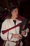 Stock photo of a man playing a musical instrument during a medieval feast at Schloss Auerbach (Auerbach Castle), Bensheim-Auerbach, Hessen, Germany, Europe.