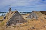 Stock photo of Re-created huts and buildings at the Norstead Viking Site (a Viking Port of Trade) backdropped by pack ice in the harbour, Trails to the Vikings, Viking Trail, Great Northern Peninsula, Northern Peninsula, Newfoundland, Canada.