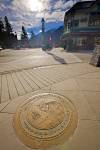 Stock photo of decorative plaque in the footpath at the corner of Banff Avenue and Wolf Street in downtown Banff, Banff National Park, Canadian Rocky Mountains, Alberta, Canada. Banff National Park forms part of the Canadian Rocky Mountain Parks UNESCO Wo