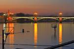 Stock photo of the lighted Puente de Isabel II Bridge across the Rio Guadalquivir River at dusk, City of Sevilla, Province of Sevilla, Andalusia, Spain, Europe.