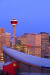 Stock photo of the Saddledome and Calgary Tower in the background at sunrise showing a bright blue clear sky, City of Calgary, Alberta.