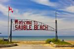 Stock photo of the Sauble Beach welcome sign on the shores of Lake Huron, Ontario, Canada.