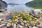 Stock photo of the rocky shoreline of Sinclair Cove, Lake Superior, Lake Superior Provincial Park, Ontario, Canada. With fog hovering in the distance, the crystal clear and calm water of Lake Superior reveals the rocky shoreline of Sinclair Cove in Lake S