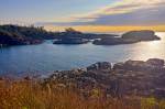 Stock photo of the rocky outcrops of South Beach in Pacific Rim National Park, Long Beach Unit, Clayoquot Sound UNESCO Biosphere Reserve, West Coast, Pacific Ocean, Vancouver Island, British Columbia, Canada. The blue sky is half covered by clouds that ha