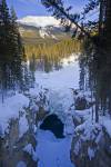 Stock photo of snow and ice covered Sunwapta Falls along the Sunwapta River in Jasper National Park in the Canadian Rocky Mountains in Alberta, Canada.