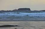 Stock photo of the stormy waves of the Pacific Ocean at the beach in Cox Bay near Tofino with the Lennard Island Lighthouse in the background, a transition area of the Clayoquot Sound UNESCO Biosphere Reserve, West Coast, Vancouver Island, British Columbi