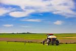 Tractor spraying crops Town of Rockglen Southern Saskatchewan Canada