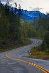Stock photo of winding road alongside snowcapped mountain peaks, Highway 31A, Slocan Valley, Central Kootenay, British Columbia, Canada.