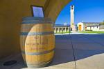 Stock photo of wine barrel and sign at the entrance to Mission Hill Family Estate Winery, Westbank, West Kelowna, Kelowna, Okanagan, British Columbia, Canada.