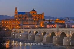Puente Romano spans Rio Guadalquivir leads to Mezquita during dusk in City of Cordoba