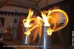 Entertainers drumsticks lit by fire medieval feast