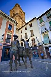 Man and donkey statue Plaza de la Romanilla and bell tower of Cathedral City of Granada