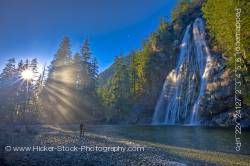 Couple enjoying view of Virgin Falls, Tofino Creek, Vancouver Island, British Columbia.