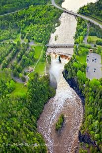 Stock photo aerial view of the Kaministiquia River and Kakabeka Falls at the Kakabeka Falls Provincial Park, Ontario, Canada. Known as Niagara of the North, Kakabeka Falls plunges 40 metres over sheer cliffs and some of the oldest fossils in the world. 