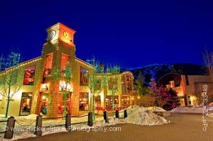 Stock photo of the BrewHouse at Whistler Restaurant and Pub with trees lit up with decorative lights at night along the Village Stroll, Whistler Village, British Columbia, Canada.