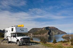 Stock photo of a camper parked an open area in Bottle Cove at the end of the Humber Arm near Lark Harbour, Newfoundland, Canada.