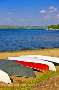 Stock photo of canoes on the sandy beach of Echo Lake in Echo Valley Provincial Park, Qu'Appelle Valley, Saskatchewan, Canada.