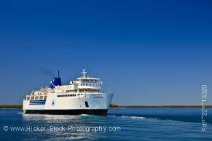 Stock photo of Chi-Cheemaun, the large passenger and vehicle ferry departing Tobermory on the Bruce Peninsula for Manitoulin Island in Lake Huron, Ontario, Canada.