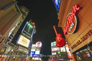 Stock photo of Eaton Centre and Yonge Dundas Square along Yonge Street at night in downtown Toronto, Ontario, Canada. Looking up toward the dark sky at the center of this city scene from street level, the tall buildings with brightly lit signs take your e
