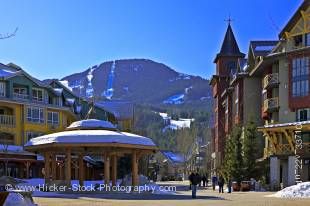 Stock photo of the gazebo in the Town Plaza along the Village Stroll with Whistler Mountain and a clear blue sky in the background, Whistler Village, British Columbia, Canada.