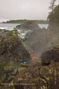 Stock photo of people bathing in the rocky pools of the geothermal hot springs at Hot Springs Cove, Openit Peninsula, Maquinna Marine Provincial Park, Clayoquot Sound, Clayoquot Sound UNESCO Biosphere Reserve, West Coast, Vancouver Island, British Columbi