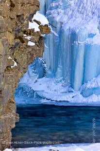 Stock photo of ice formations at the base of the Upper Falls along the Johnston Creek during winter, Johnston Canyon, Banff National Park, Canadian Rocky Mountains, Alberta, Canada. 