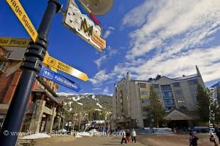 Stock photo of Mountain Square along the Village Stroll with Blackcomb Mountain and blue sky in the background, Whistler Village, British Columbia, Canada.