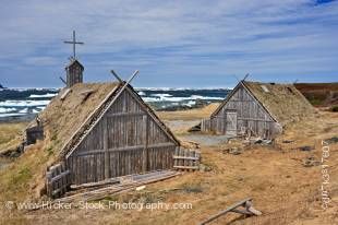 Stock photo of Re-created huts and buildings at the Norstead Viking Site (a Viking Port of Trade) backdropped by pack ice in the harbour, Trails to the Vikings, Viking Trail, Great Northern Peninsula, Northern Peninsula, Newfoundland, Canada.