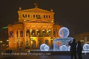 Stock photo of the exquisitely detailed Old Opera House, Alte Oper Frankfurt, and its fountain decorated with lights, at night, downtown Frankfurt, Hessen, Germany, Europe.