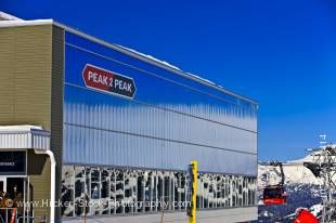 Stock photo of the Peak 2 Peak Gondola Terminal at Roundhouse Lodge on Whistler Mountain, Whistler Blackcomb, Whistler, British Columbia, Canada. The bright blue sky above reflects onto the shiny edifice of this building.