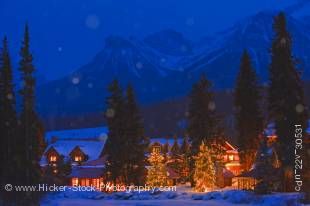Stock photo of a winter night scene of the Post Hotel located on the snow covered banks of the Pipestone River, Lake Louise, Banff National Park, Canadian Rocky Mountains, Alberta, Canada.