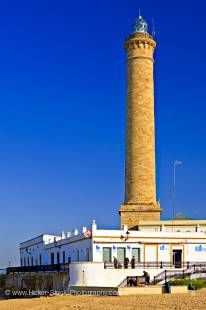 Stock photo of the light tower, Punta del Perro in the town of Chipiona, seen from Playa de Regla (beach), Costa de la Luz, Province of Cadiz, Andalusia (Andalucia), Spain, Europe.