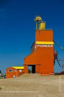 Stock photo of tall red grain elevator in the town of Coronach, Southern Saskatchewan, Canada.